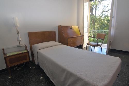 a bedroom with a bed and a dresser and a window at Albergo Magenta in Casella