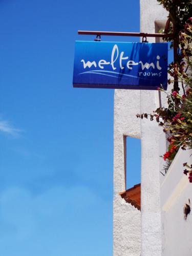 a blue sign on the side of a building at Meltemi in Vourkarion