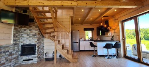 a living room with a staircase in a tiny house at Bieszczadzkie Chaty in Polańczyk