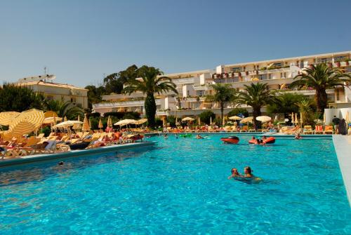 a group of people in a swimming pool at a resort at BmyGuest - Oura Beach Studio I in Albufeira