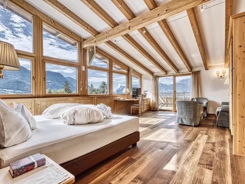 - une chambre avec un lit dans une pièce dotée de fenêtres dans l'établissement Hotel Traubenheim, à Tirolo