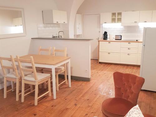 a kitchen and dining room with a table and chairs at Issoire centre, T2 Bergère avec parking in Issoire