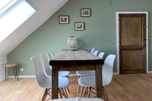 a dining room with a table and white chairs at Authentic Stays - 5p-apartment in Eijsden
