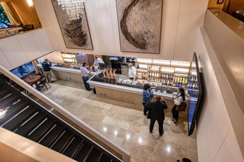 a group of people walking down an escalator in a store at Hotel Castilla Vieja in Palencia
