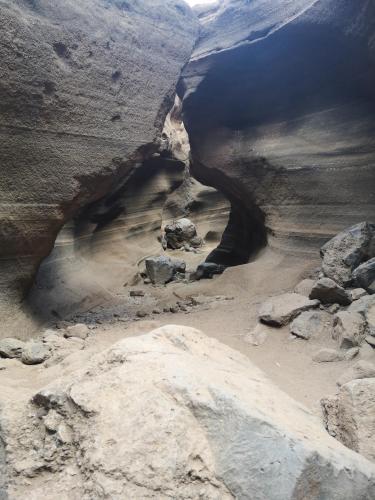 a cave in a canyon with rocks and water at La Casona Canaria Boutique Home B & B in Agüimes