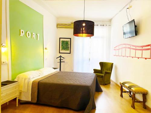 a bedroom with a bed and a chair in it at Hostal Portugal in Barcelona
