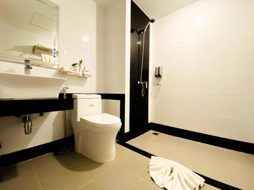 a bathroom with a white toilet and a sink at Ratana Angkor Hotel in Siem Reap