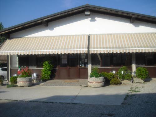 a building with awning and plants in front of it at Agriturismo la Chioccia in Campagna Lupia