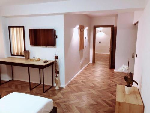a room with a bed and a table and a hallway at Hotel Lido in Durrës