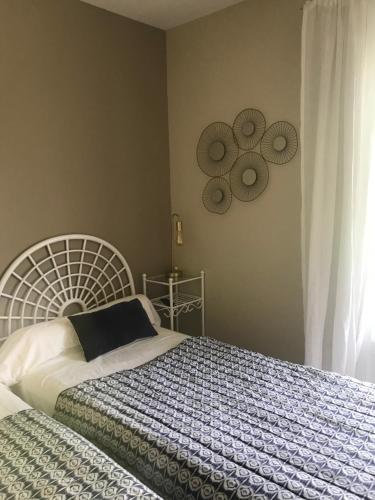 a bedroom with a bed with a blue and white blanket at L'Acqua Viva in Calacuccia