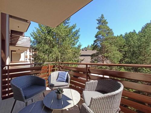 a patio with two chairs and a table on a balcony at Apartman Relax Lux - Vila Peković in Zlatibor