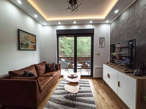a living room with a couch and a table at Apartman Relax Lux - Vila Peković in Zlatibor