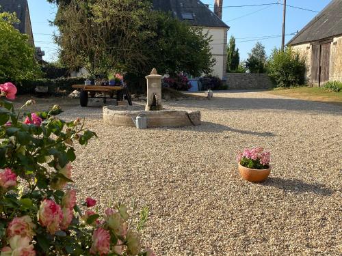 
a garden area with a table, chairs, and a fire hydrant at B&B Les Eaux de la Petite Fontaine in La Souterraine
