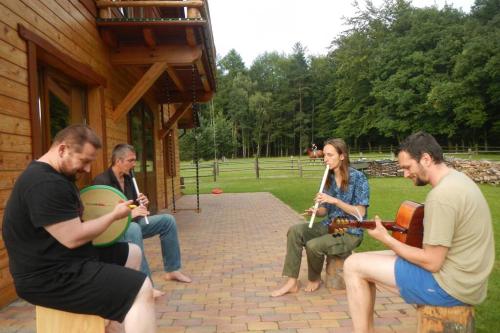 a group of people sitting around playing instruments at Na Wysokiej Górce- Agroturystyka in Grabowiec