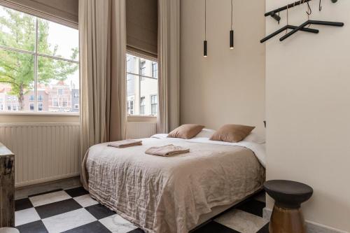 a bedroom with a bed and a window at HARBOR HOUSE ZEELAND - nl in Goes