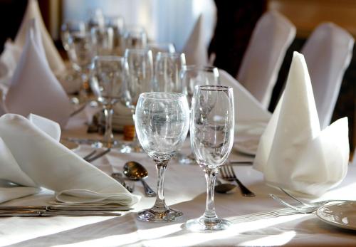 a table with wine glasses and napkins on it at Cressfield Country House Hotel in Ecclefechan