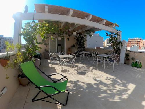 a patio with chairs and tables on a roof at Palazzo Cesare - Monopoli in Monopoli