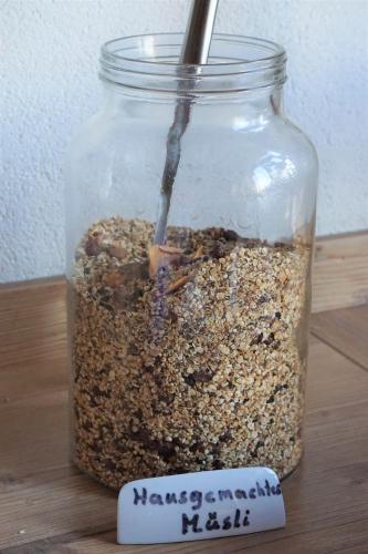 a jar of granola with a measuring stick in it at Aparthotel Sunrise in Ramsau am Dachstein