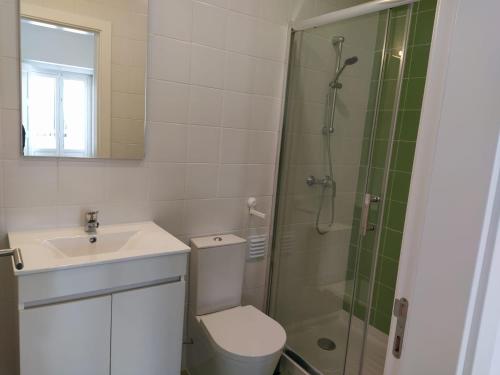 a bathroom with a shower and a toilet and a sink at Urban Apartment in Faro