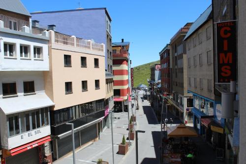 an empty street in a city with tall buildings at Hotel Cims Pas de La Casa in Pas de la Casa