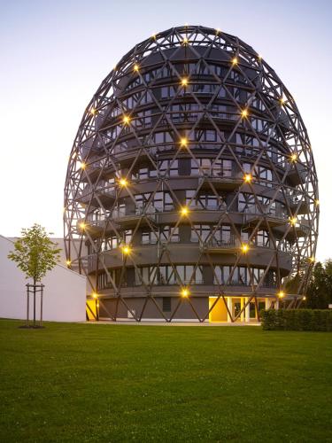 a large metal building with lights in a field at Hotel Oversum Winterberg Ski- und Vital Resort in Winterberg