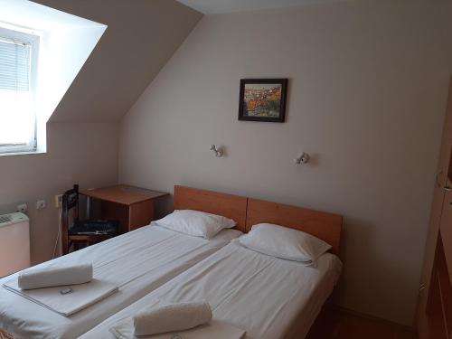 a bedroom with a bed with a laptop on it at Guest House Diel in Veliko Tŭrnovo