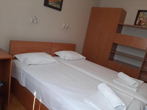 a bedroom with a bed with two white pillows at Guest House Diel in Veliko Tŭrnovo
