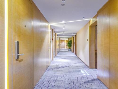 a corridor of an office building with a long hallway at Lavande Hotel (Shenyang Olympic Center Wanda Branch) in Shenyang