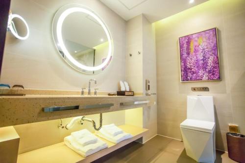 a bathroom with a sink and a mirror at Lavande Hotel Xuzhou East High-speed Rail Station Jinshanqiao Development Zone Branch in Xuzhou