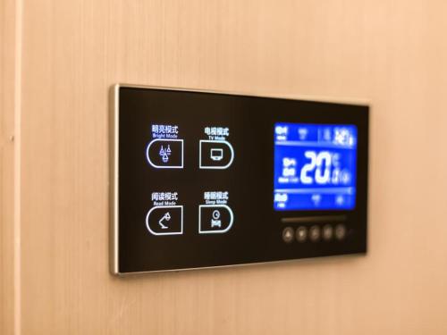 a digital clock on a wall on a wall at Lavande Hotel Langfang City Government in Langfang