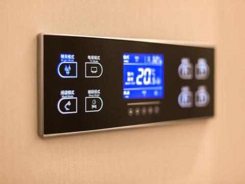 a digital clock on a wall on a wall at Lavande Hotel Langfang City Government in Langfang