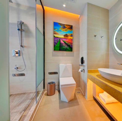 a bathroom with a sink and a shower at Lavande Hotel Nanchang Hongdu Middle Avenue Provincial TV Station Branch in Nanchang