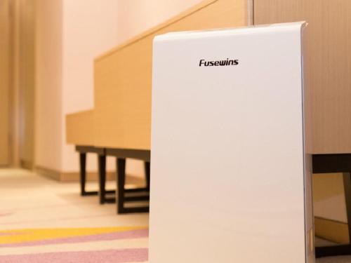 a white sign with the word flectrum next to a piano at Lavande Hotel (Guangzhou North Railway Station Branch) in Huadu