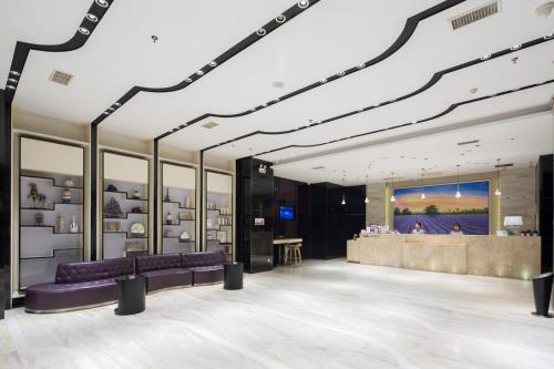 a store lobby with purple couches and a bar at Lavande Hotel Changsha High-speed Railway Station Shuling in Changsha