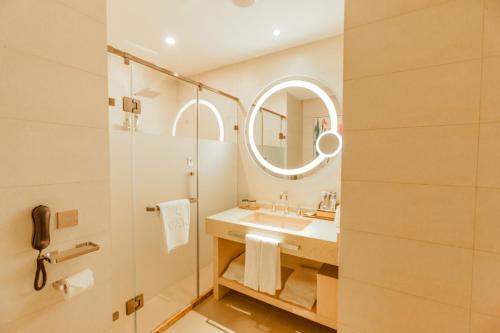 a bathroom with a sink and a mirror at Lavande Hotel Zhangjiakou Victoria Plaza in Zhangjiakou