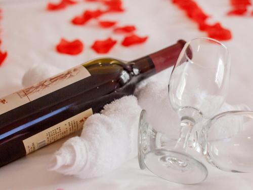 a bottle of wine sitting next to a glass at Lavande Hotel Changsha Xingsha Center in Xingsha