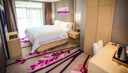 a hotel room with a bed with pink flowers on the floor at Lavande Hotel Xiaogan Beijing Road Branch in Xiaogan