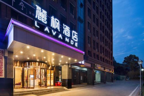a building with a neon sign on the side of it at Lavande Hotel (Changsha City Government Branch) in Changsha