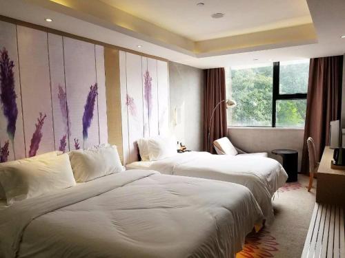 Ένα ή περισσότερα κρεβάτια σε δωμάτιο στο Lavande Hotel Shenzhen Baoan Haiya Binfencheng
