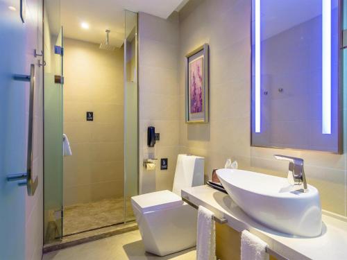 a bathroom with a sink and a toilet and a shower at Lavande Hotel Qiqihar Supervisory Office in Qiqihar