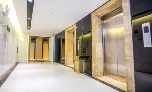 a hallway of elevators in a building at Lavande Hotel Xiaogan Beijing Road Branch in Xiaogan