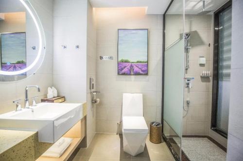 a bathroom with a sink and a shower at Lavande Hotel Jiujiang Railway Station Branch in Jiujiang
