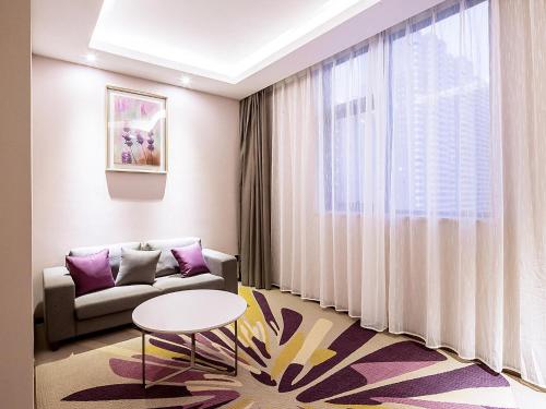 a living room with a couch and a table at Lavande Hotel Changsha Xingsha Center in Xingsha