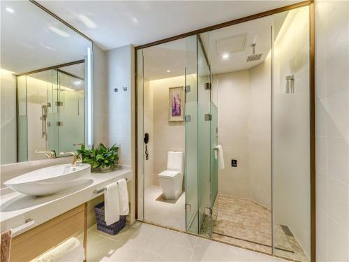 a bathroom with a sink and a toilet and a shower at Lavande Hotel Tangshan Convention and Exhibition Yuanyang City in Tangshan