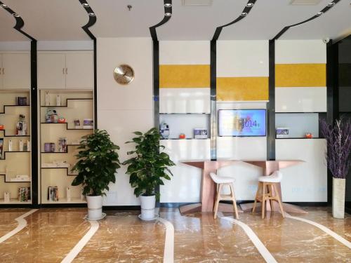 a room with plants and a table and two stools at Lavande Hotel Jinan Second Ring East Road Quanfu Overpass Branch in Jinan