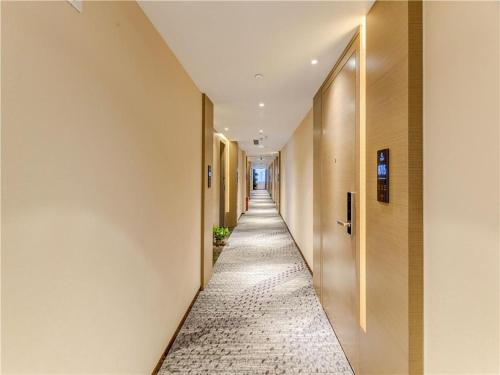 a long hallway with a tile floor in a building at Lavande Hotel Tangshan Convention and Exhibition Yuanyang City in Tangshan
