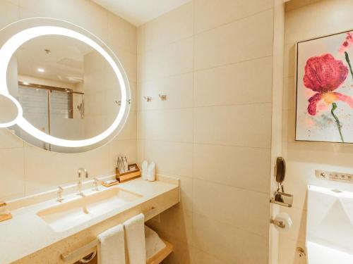 a bathroom with a sink and a mirror at Lavande Hotel Zhangjiakou Victoria Plaza in Zhangjiakou