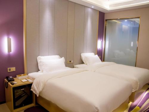 Ένα ή περισσότερα κρεβάτια σε δωμάτιο στο Lavande Hotel Shiyan Sanyan Branch