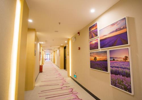 a corridor in a hospital with paintings on the walls at Lavande Hotel Chaozhou Plaza Branch in Chaozhou