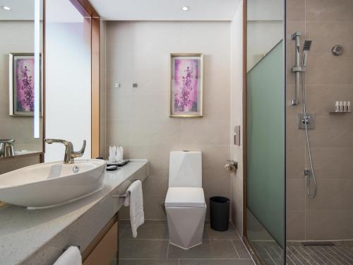 a bathroom with a sink and a toilet and a shower at Lavande Hotel Yangchun Donghu in Yangjiang